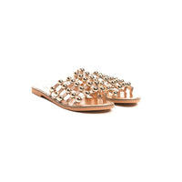 Rose gold flat slide sandals with studded lattice straps and open toe