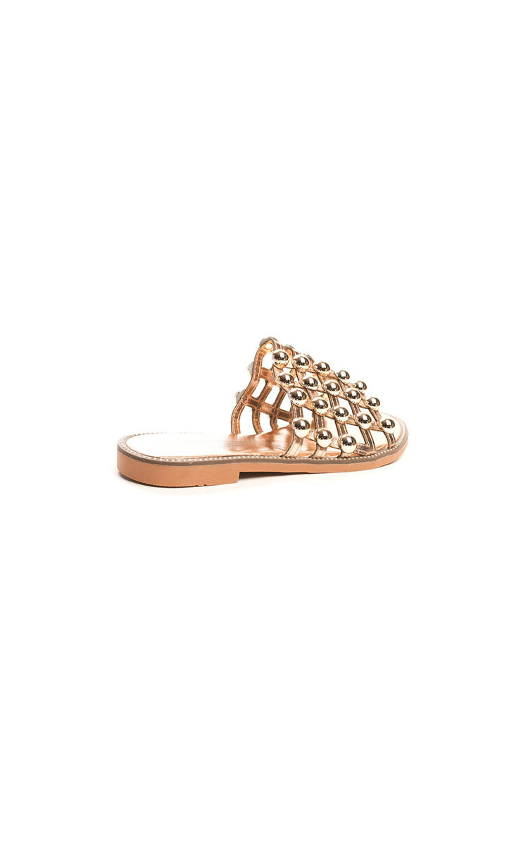 Nude flat slide sandals with studded lattice upper, low flat sole side view