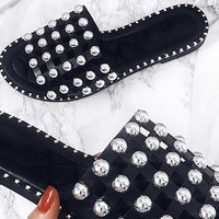 Black flat slides with silver studded lattice straps and scalloped stud trim
