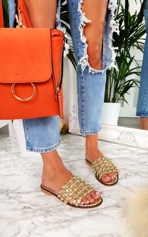 Nude flat slide sandals with studded lattice straps, open toe and low sole