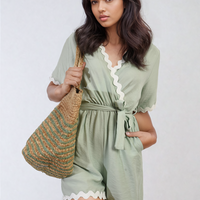 Light green wrap playsuit with white scalloped trim and waist tie, short sleeves
