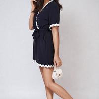 Navy wrap playsuit with scalloped white trim and waist tie, short sleeves