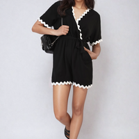 Black wrap playsuit with scalloped V neckline and waist-tie belt