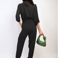 Black back view button-front collar jumpsuit with drawstring waist and cuffed jogger legs.