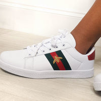White low-top trainers with colorful side stripe patch, lace-up front