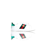 White trainers with green and red side patch, angled with mirrored view