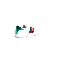 White trainers with green and red side panel detail on back half