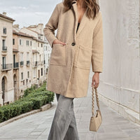 Beige textured button-front long jacket with front patch pockets and long sleeves.