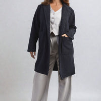 Dark navy textured button-up jacket with front flap pockets and long sleeves