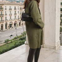 Olive green textured button-front long jacket with front pockets and long sleeves.