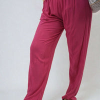 Fuchsia high-waist drawstring trousers with side pockets, flowy wide-leg silhouette.