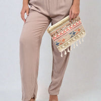 Taupe high-waist drawstring trousers with side pockets and gathered waist detail