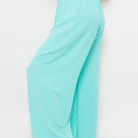 Turquoise wide-leg trousers with gathered elastic waist and flowing wide hem