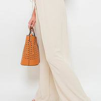 Beige wide-leg trousers with drawstring gathered waist and soft, billowy fabric