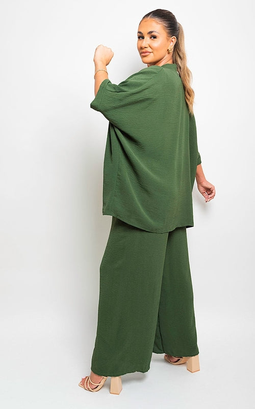 Green wide-leg trousers with drawstring gathered waist and relaxed drape