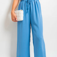Blue wide-leg trousers with elastic drawstring waist and roomy straight drape