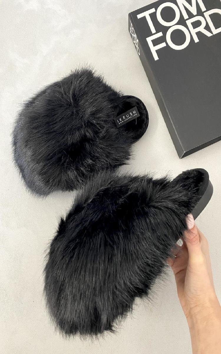 Black fuzzy open-back slippers with rounded toe and small logo patch