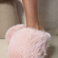 Pink faux fur slide slippers with open back and rounded toe