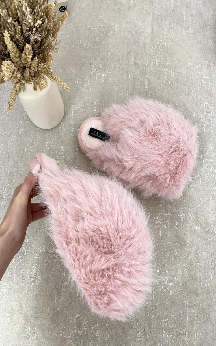 Pink fuzzy open-back slippers with soft fur uppers and black logo patch