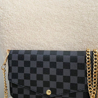 Black check clutch bag with front flap and gold chain shoulder strap