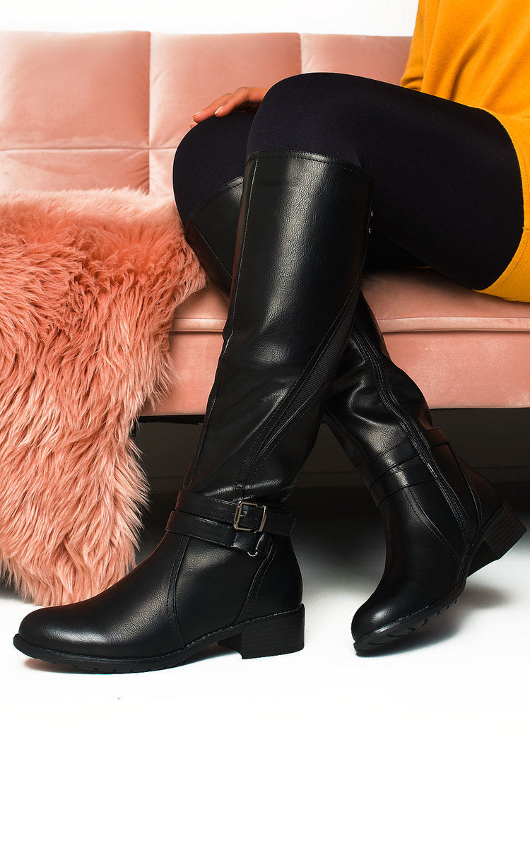 Black knee-high boots with buckle strap and chunky low heel