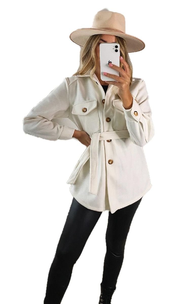 White belted jacket with flap pockets and gold button front, tied waist.