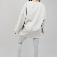 Light grey oversized crewneck sweatshirt with long sleeves, back view