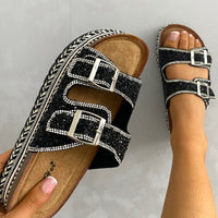 Embellished black platform sandals with two square buckles and crystal straps.
