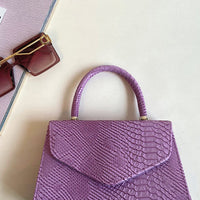 Faux Leather Handbag in Lilac with Top Handle and Chain Strap
