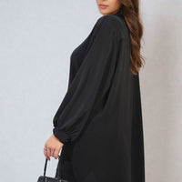Black oversized collared button-down top with long sleeves and curved hem