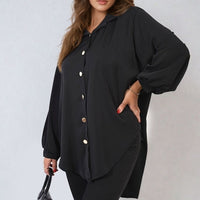 Oversized black button-down shirt with pointed collar and long puff sleeves, front buttons