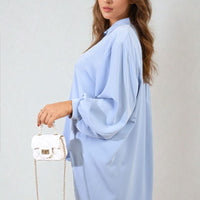 Light blue oversized collared button-down top, draped long sleeves, button placket