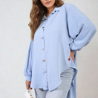 Light blue oversized collared button-down top with long sleeves and gold-tone buttons