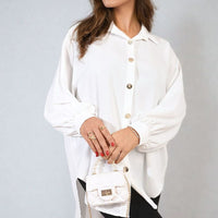Oversized collared white button-down shirt with button-front placket and roomy long sleeves