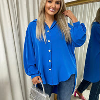 Royal blue oversized collared button-down top with long puff sleeves and front buttons