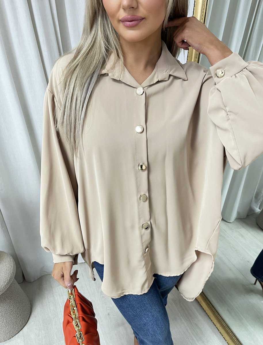 Oversized collared beige button-down shirt close-up with front buttons and soft puff sleeves
