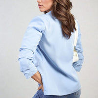 Light blue blazer jacket, open front with ruched sleeves and front pockets, side view