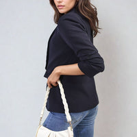 Black open-front blazer jacket with ruched sleeves and front pockets, side view