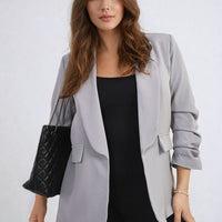 Open-front ruched-sleeve blazer jacket in light gray with front pockets and wide lapels.