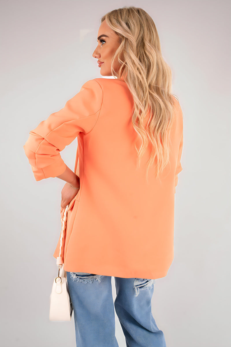 Orange open front blazer jacket with ruched sleeves and back drape