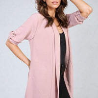 Rose pink open-front cardigan with short puff sleeves and draped hem