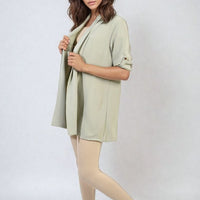 Light yellow open-front cardigan with rolled short sleeves and side slits