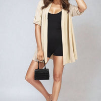 Beige open-front cardigan with short roll-up sleeves and long drape hem