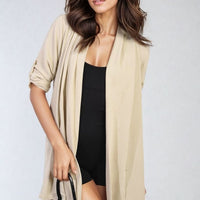 Open-front cardigan in light yellow/cream with roll-up sleeves and draped front