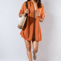 Orange open-front cardigan with rolled sleeves and button cuff detail