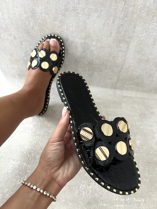 Black studded flat sandals with mesh-like circular strap inserts