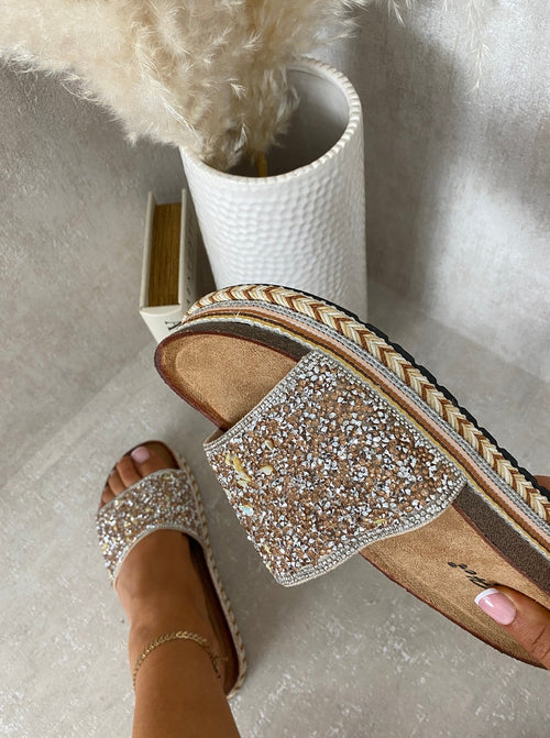 Gold-sparkle platform slide sandals with stone embellishments and braided trim