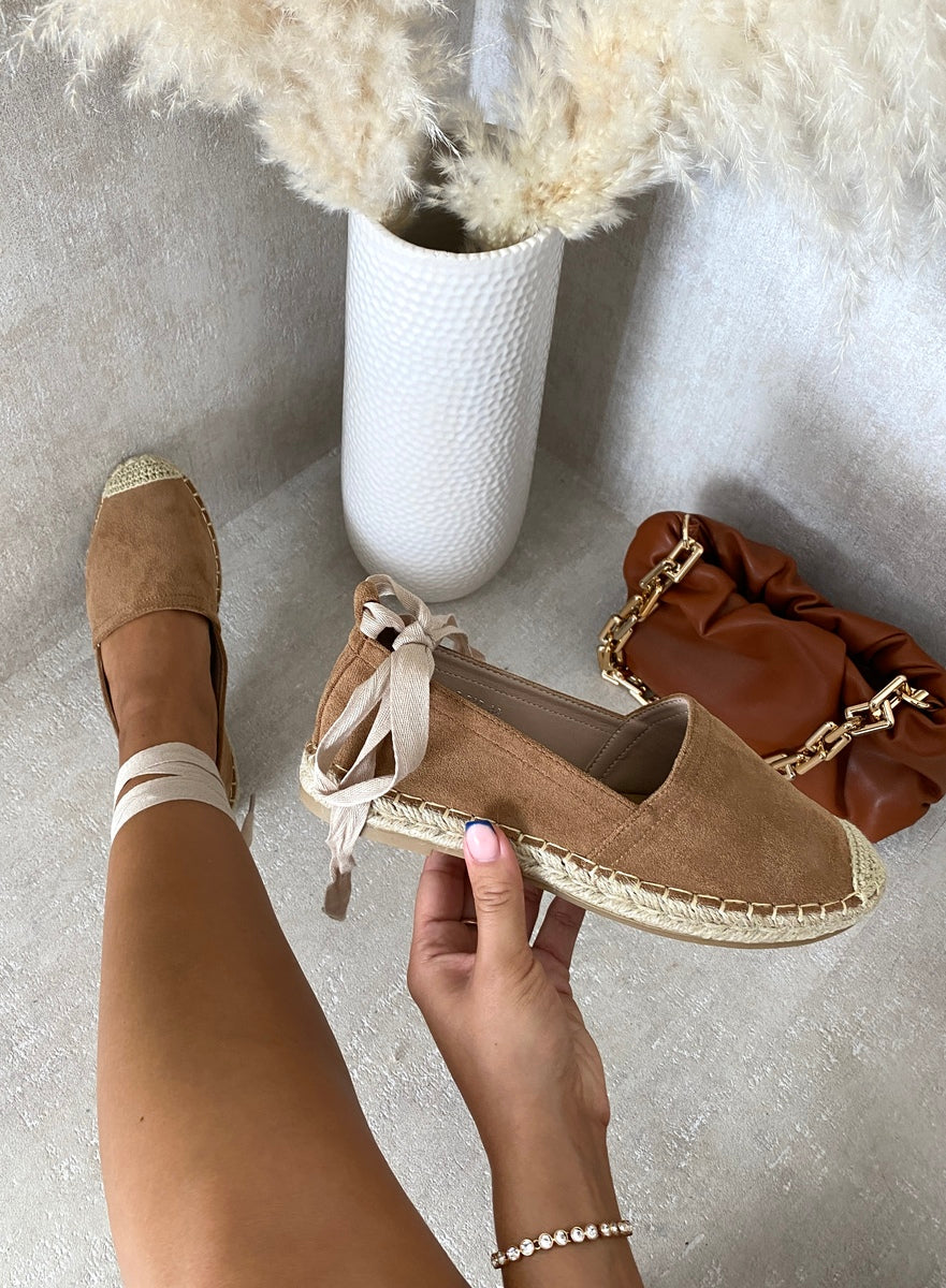 Tan suede espadrille with knotted ankle ties and woven toe cap, close-up