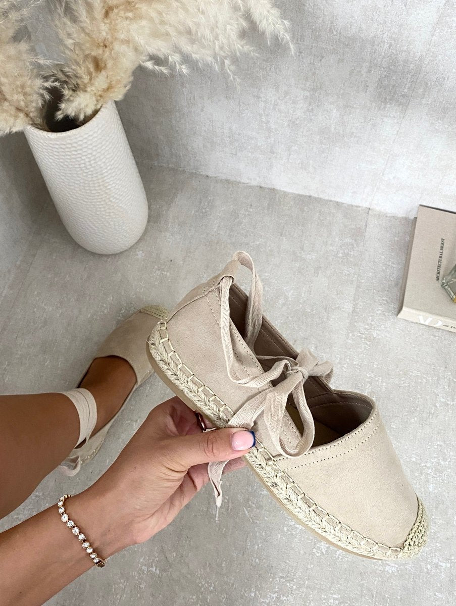 Beige espadrilles with ankle ties and woven toe cap, side view