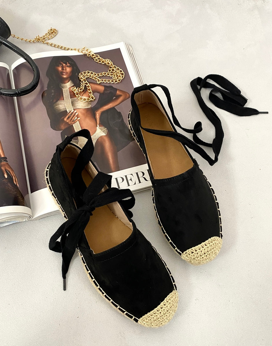 Black suede espadrilles with lace-up ankle ties and woven toe caps, pair view